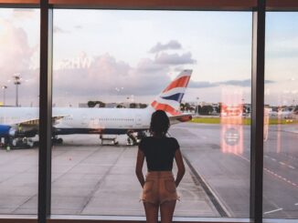 Photo of Woman Standing Near Glass Wall