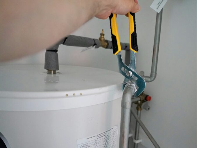 person holding yellow and gray hand tool