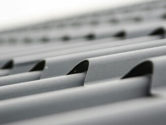 Detailed close-up of grey metal roof sheets showcasing texture and design.