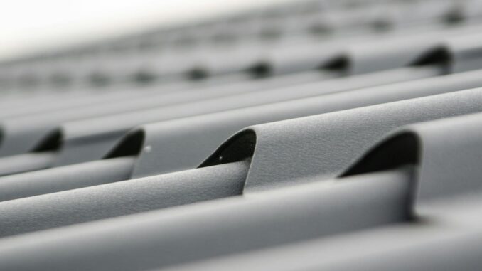 Detailed close-up of grey metal roof sheets showcasing texture and design.